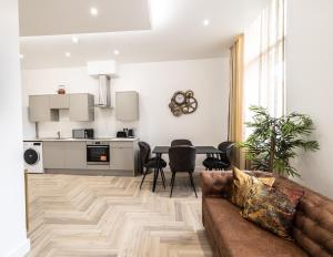 a living room with a couch and a table at The Pocklington Aparthotel - Luxury 1 & 2 Bed Serviced Apartments, City Centre, Perfect For Families, Contractors and Businesses in Leicester