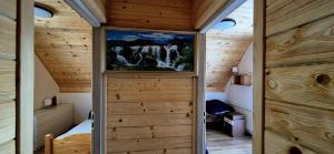 a room with a waterfall painting on the wall at Domek Na Hawajach in Polana