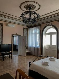 a bedroom with a bed and a mirror and a piano at Приватна садиба Фортеця Малехів in Lviv