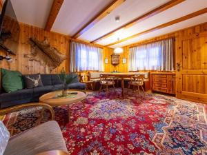 a living room with a couch and a table at das Sopherl in Sonnenalpe Nassfeld