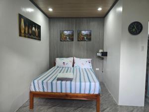 a bedroom with a bed in a room at Mollucan Suite Moalboal in Moalboal