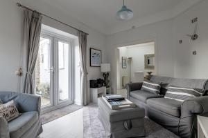 a living room with a couch and a table at Bakers Close - Elie in Elie