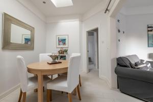 a dining room with a table and a couch at Bakers Close - Elie in Elie