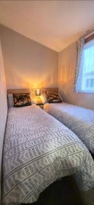 a bedroom with two beds and a window at Graham's Dream in Heysham +51 photos