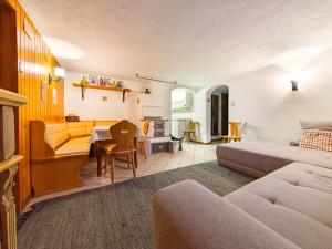a living room with a bed and a couch at das Sopherl in Sonnenalpe Nassfeld +27 photos