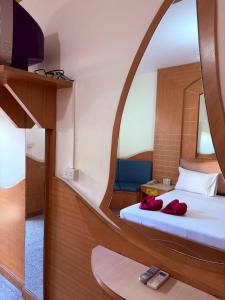a room with a bed with a round mirror at Picnic Si Racha in Ban Fang Daeng
