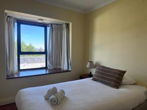 a bedroom with a bed with two towels on it at Hotel del Volcán in Pucón