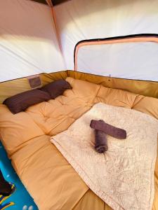 a bed in a tent with a sock on it at baan sugaiyah in Phra Ae beach