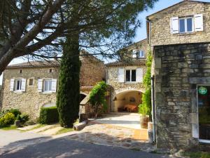 a large stone house with a driveway at Gîte Côté Sud in Vagnas