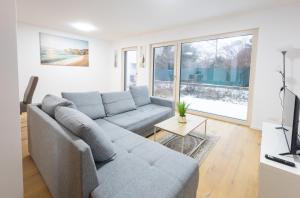 a living room with a couch and a tv at Danube Tower holiday in Vienna