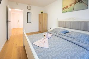 a bedroom with a large bed with a pink robe on it at Danube Tower holiday in Vienna