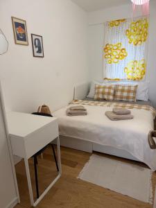 a small bedroom with a bed and a desk at Sea View Apartment in Jelsa