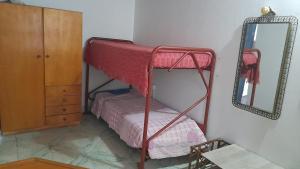 a bedroom with a bunk bed and a mirror at Graciana Quequén in Necochea