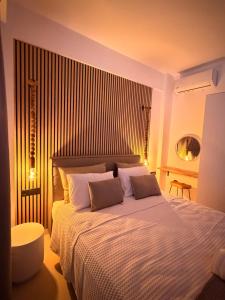 a bedroom with a large bed with two pillows at Kudos Luxury villas in Korinthos +30 photos