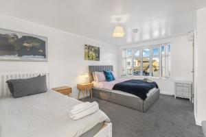 a bedroom with two beds and a window at Badger Haven, Apartment 2 in Brackley