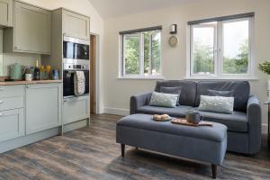 a living room with a couch and a table at Lakeside Lodge in Eastleigh +12 photos