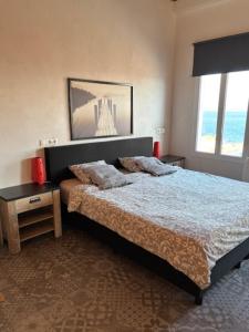 a bedroom with a bed and a picture of a bridge at Casa Laryssiou in Gythio