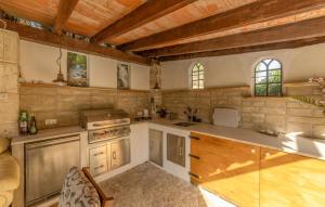 a large kitchen with wooden ceilings and wooden counters at Can Taco in Galilea