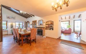 a dining room and living room with a table and chairs at Can Taco in Galilea