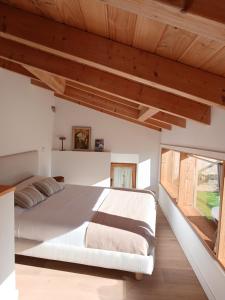 a bedroom with a large bed and a large window at Casa Potenta in Llimiana +85 photos