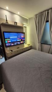 a bedroom with a large flat screen tv on the wall at Apt 18 - VR Village in São Luís