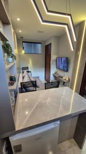 a kitchen with a white counter top in a room at Apt 18 - VR Village in São Luís +5 photos