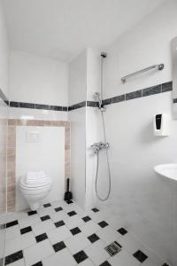 a bathroom with a shower and a toilet and a sink at Sonne Hotel in Herne +37 photos