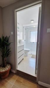 a bathroom with a sink and a toilet and a mirror at Meu Sonho Cascais - Praia in Alcabideche +17 photos