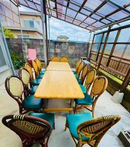 a wooden table and chairs on a patio at Biwa Asahi 家族友人大人数ok BBQok in Takashima