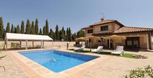 a swimming pool in front of a house at Casa Jardin del Valle. TuCasaTemporal in Seseña