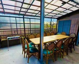 a wooden table and chairs on a patio at Biwa Asahi 家族友人大人数ok BBQok in Takashima
