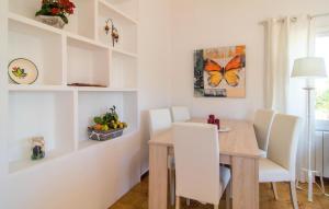 a dining room with a table and a butterfly on the wall at Sa Caseta De Portocolom in Felanitx