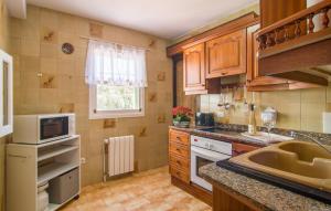a kitchen with a sink and a microwave at Sa Caseta De Portocolom in Felanitx