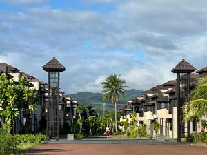 a row of apartment buildings with palm trees in the background at Casita Luna in San Juan