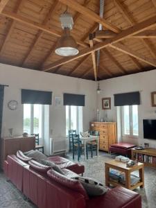 a living room with couches and a table with a dining room at Casa Laryssiou in Gythio