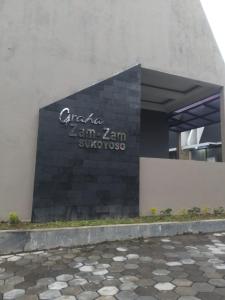 a building with a sign on the side of it at Herald homestay wonosobo in Wonosobo