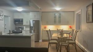 a kitchen and dining room with a table and chairs at Luxurious Two Bedroom Apartment in Burlington