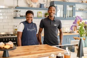two men are standing in a kitchen at Long Story Guest House in Plettenberg Bay +137 photos