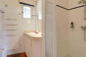 a white bathroom with a sink and a shower at Villa Marie in Vence +29 photos