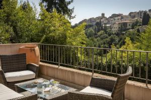 a balcony with two chairs and a table with a view at Villa Marie in Vence