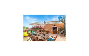 a house with a patio with a table and chairs at Torre De Heretat in Canyamel