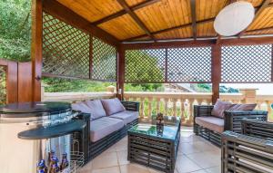a screened in porch with a couch and a table at Torre De Heretat in Canyamel