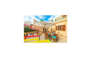 a house with a patio with a table and an umbrella at Torre De Heretat in Canyamel +39 photos