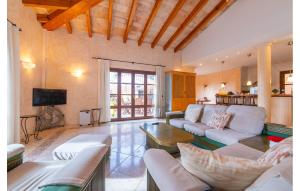 a living room with white couches and a tv at Torre De Heretat in Canyamel
