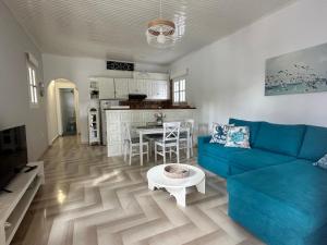 a living room with a blue couch and a table at Achladies Cottages in Achladies +9 photos