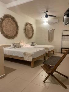 a bedroom with two beds and a fan at Nuiya Hoteles Centro in Sayulita +38 photos