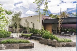 a house with a courtyard with flowers and plants at Volcano View Loft, Puebla Skyline1801 in Puebla
