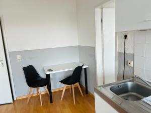 a kitchen with two chairs and a sink at Hotel Westend in Cologne +61 photos
