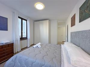 a bedroom with a large bed and a window at BBkey Corte San Daniele in San Daniele del Friuli