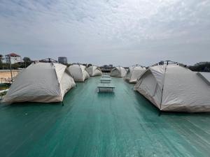 a row of tents sitting on top of water at AHHA Floatel Kampot in Kampot